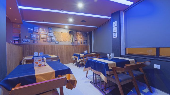 Bar tables and booth seating in blue light