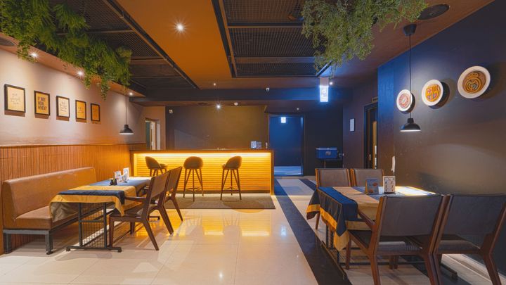 The bar counter with stools under warm lighting