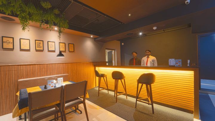 Bar staff behind the lit counter