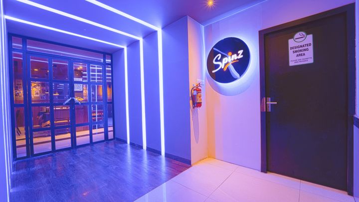 The Spinz sign at the bar entrance in blue light