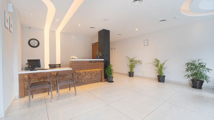 The lobby with potted plants and the reception desk
