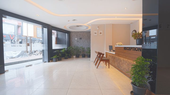 Lobby seating beside tall street-facing windows