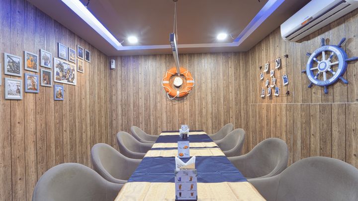 A private dining room with timber walls and nautical decor