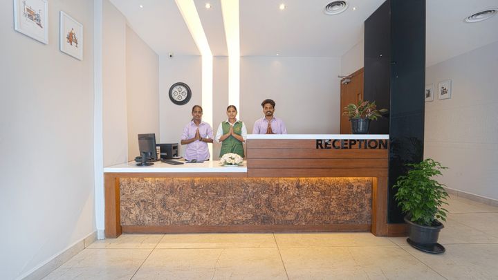 Front desk staff greeting guests at reception