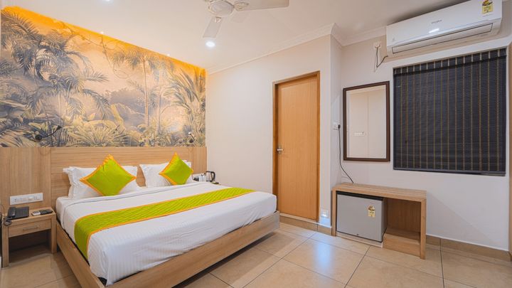 Room with a king bed, wooden chairs and a window