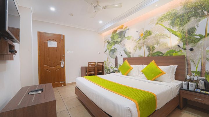 King bed, desk and television in a guest room