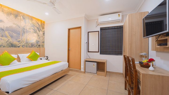 Guest room with a king bed and a work desk by the window