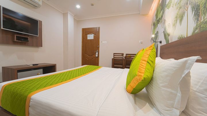 Close view of a made bed with cushions and a bed runner