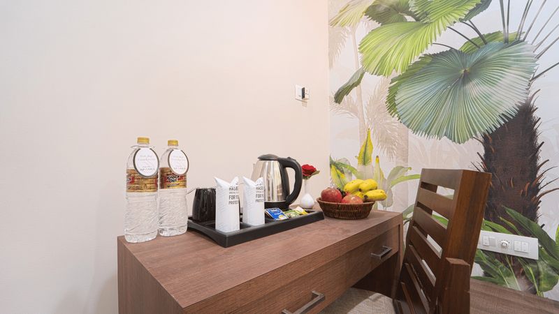 Kettle, cups and bottled water on the in-room tea tray